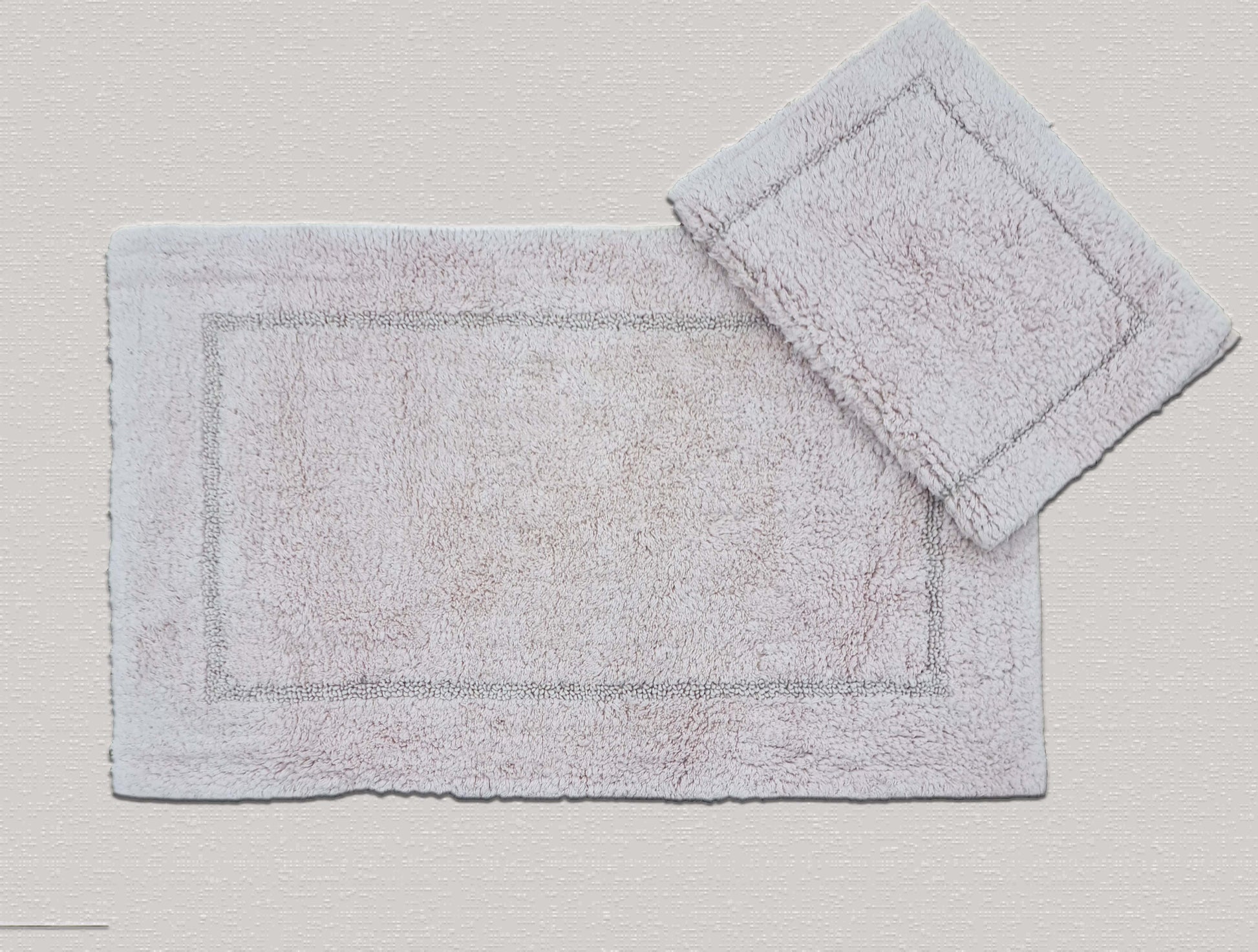 A bath mat crafted entirely from cotton